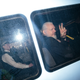 Julian Assange gestures to the media from a police vehicle on his arrival at Westminster Magistrates court on April 11, 2019 in London, England